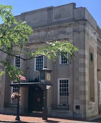 Historic building with large windows and ornate architecture, featuring a clock and decorative elements, representing a venue for events in the context of wedding expos and celebrations.