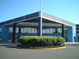 Basking Ridge Country Club building exterior with modern architecture, surrounded by landscaped greenery, featured in the context of New Jersey's Biggest Winter Wedding Expo event.