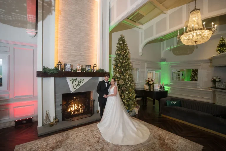 Maura in the Jumping Brook ballroom by the fireplace and Christmas tree