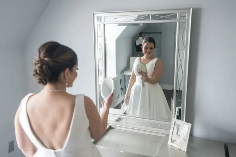 Maura checking her gown in the mirror while getting ready