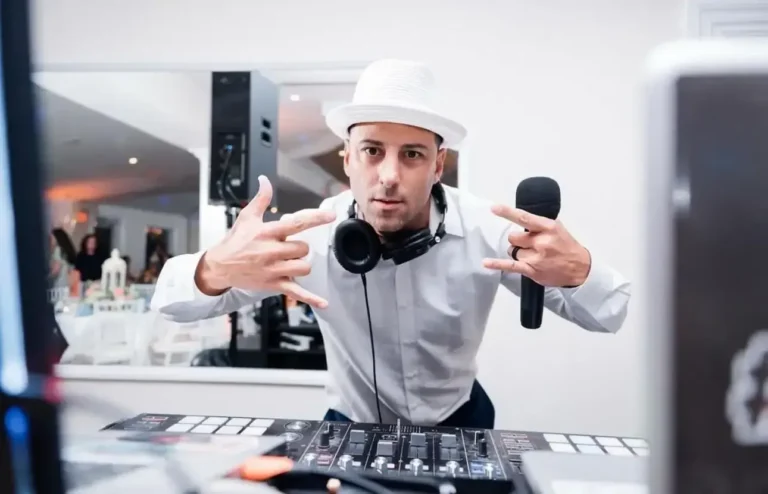 FNA Events MC with a microphone and headphones at the DJ booth