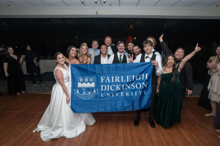College friends with the Fairleigh Dickinson University flag on the dance floor