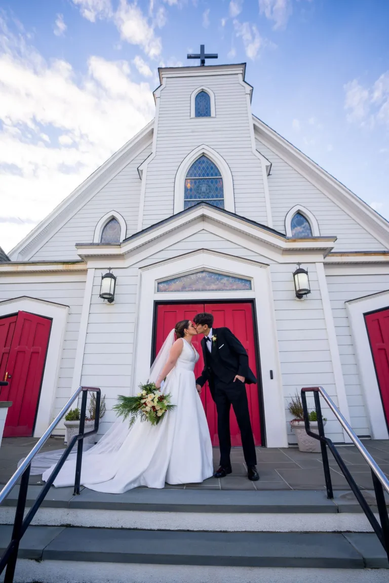 Maura and Christopher kiss on the steps of The Church of the Precious Blood
