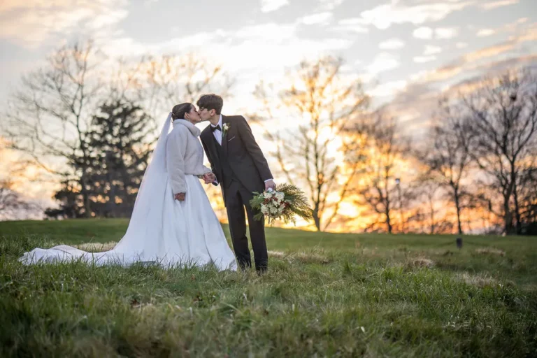 Maura and Christopher kiss at sunset at Jumping Brook Country Club