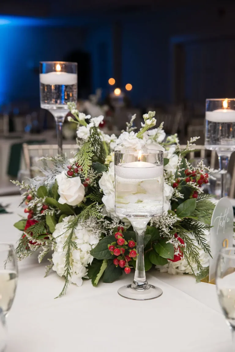 Reception centerpiece with floating candles and winter florals