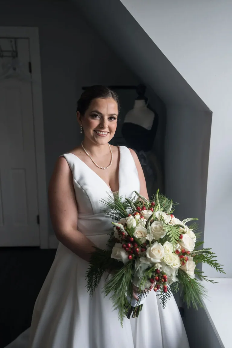Maura holding her winter bouquet before the ceremony