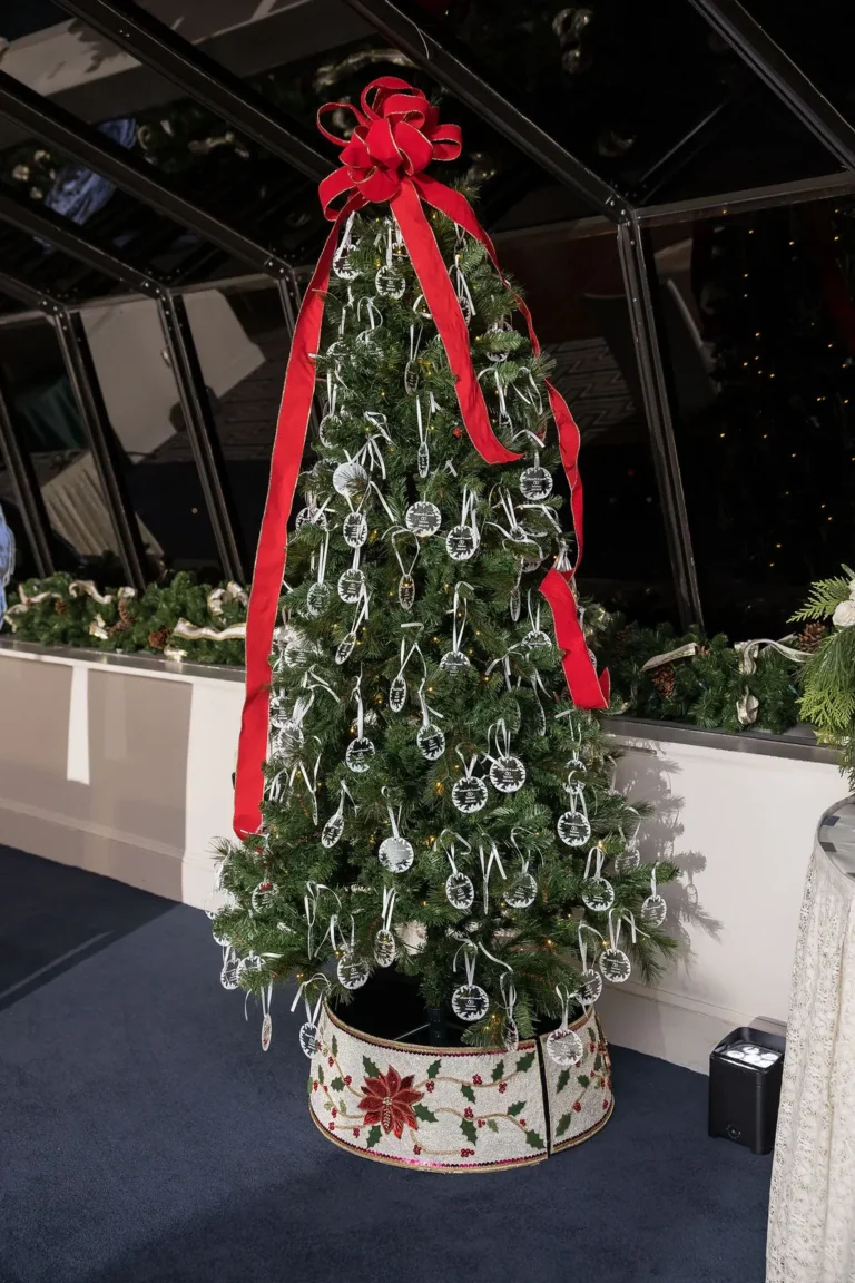Christmas tree decorated with red ribbon at the reception