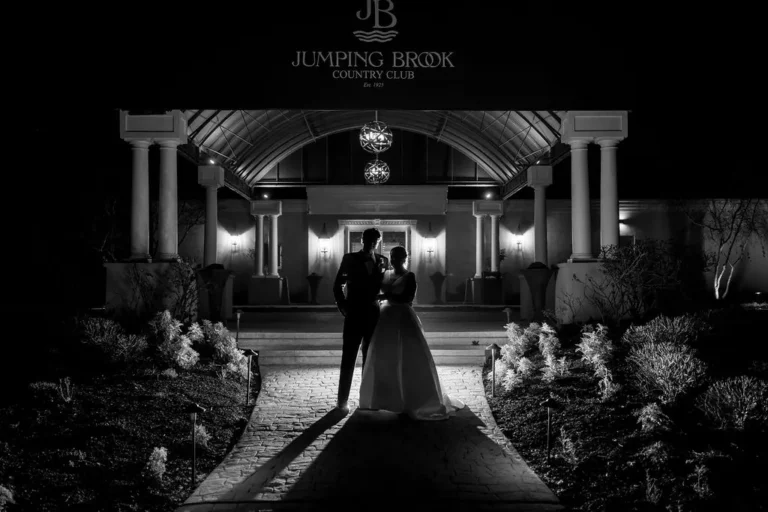 Black and white night portrait at the entrance of Jumping Brook Country Club