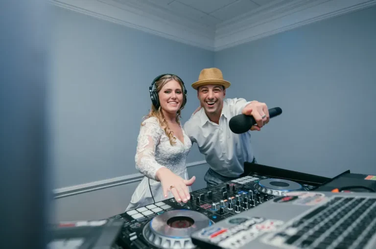 A bride celebrating with her Fresh New Angle Events DJ behind the mixer