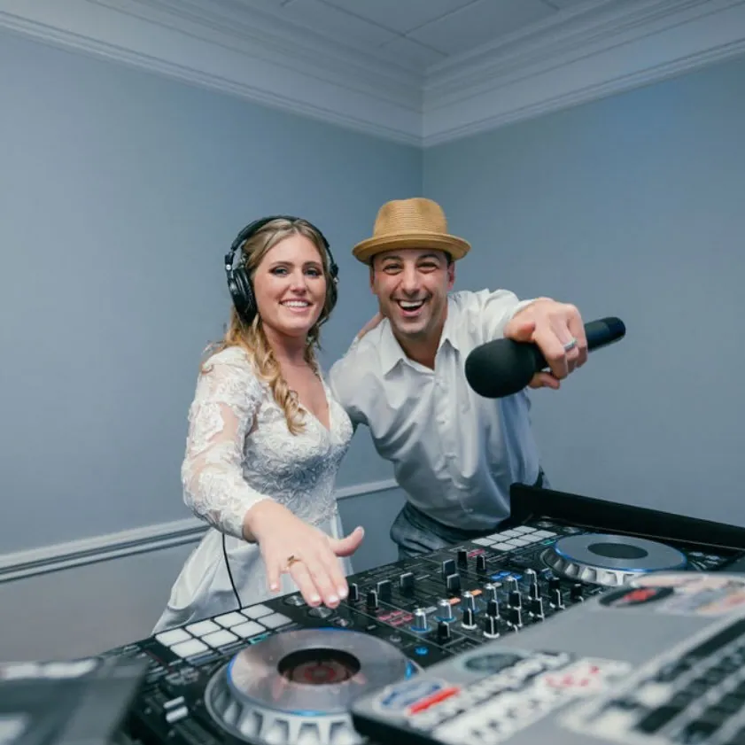 Bride and FNA Events DJ at the decks with a microphone