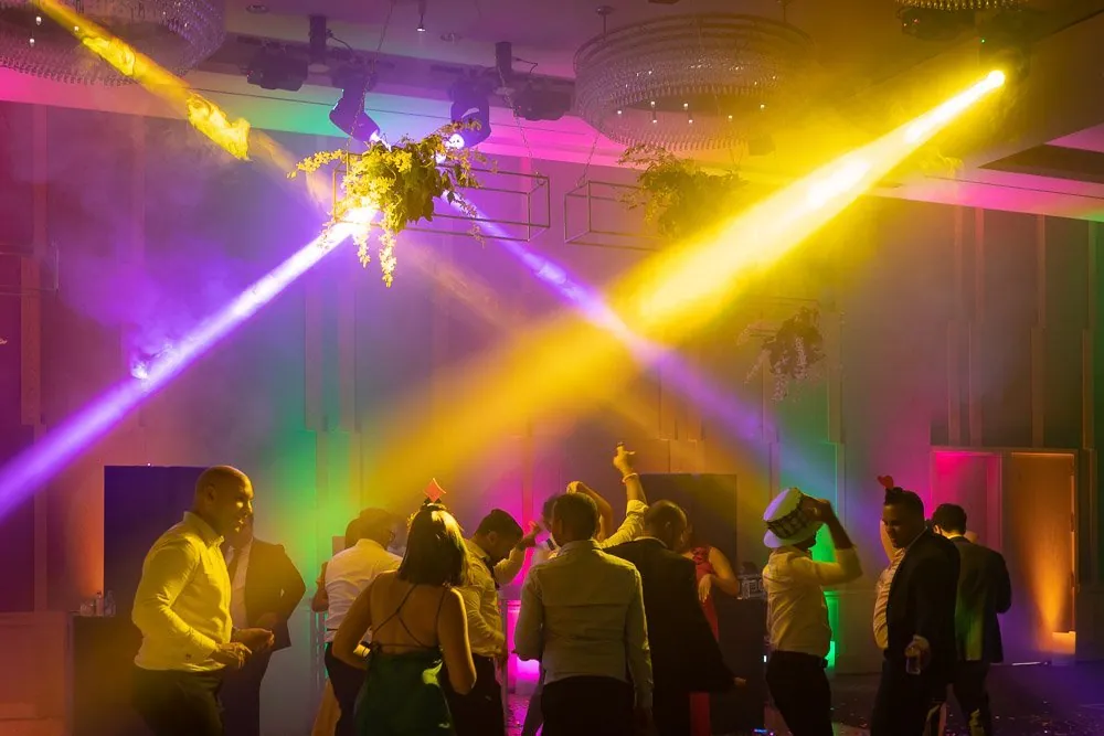 Students dancing under colorful intelligent lighting
