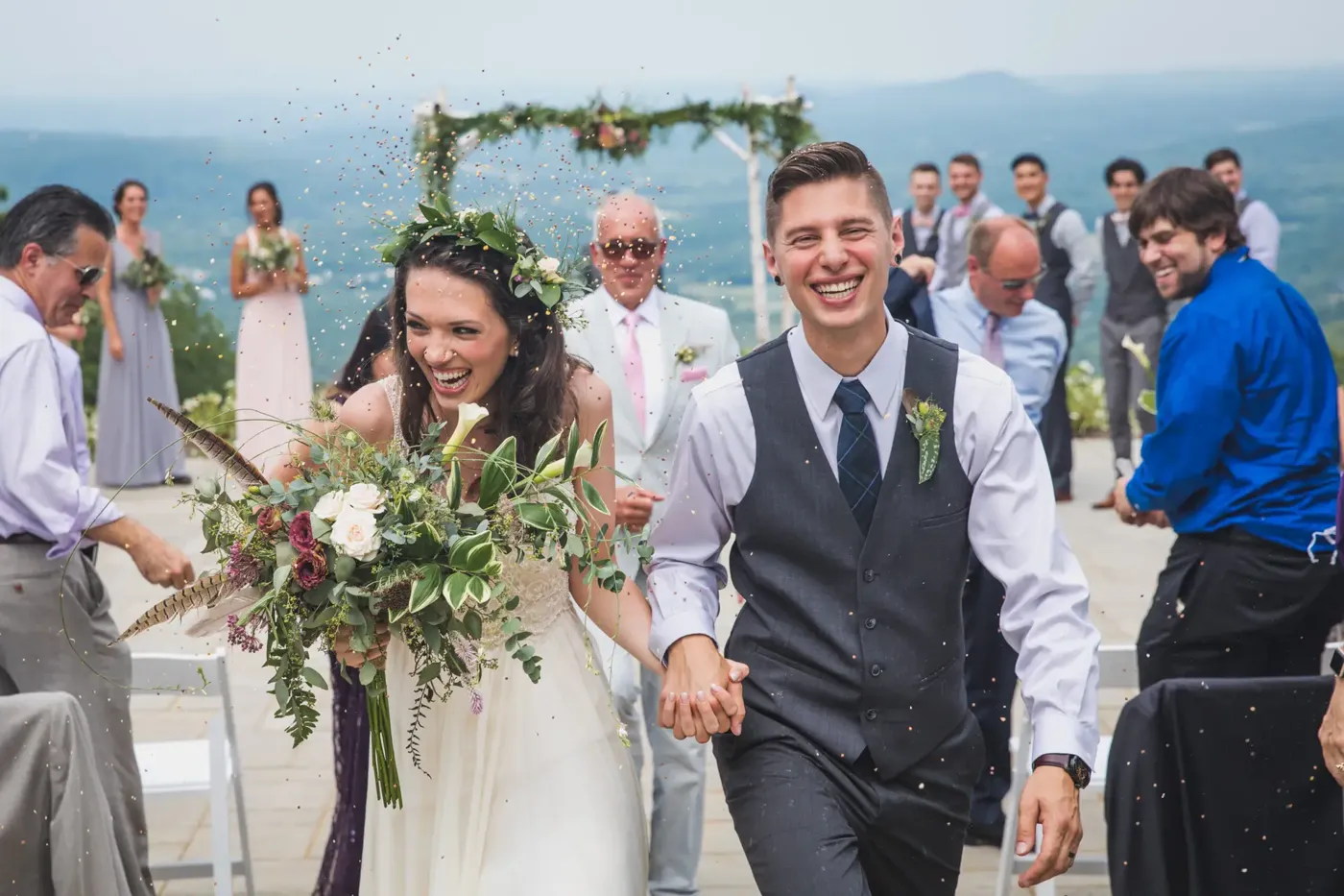 Bride and groom walking up the aisle laughing, photo by Anna Ryabtsov for Fresh New Angle Events