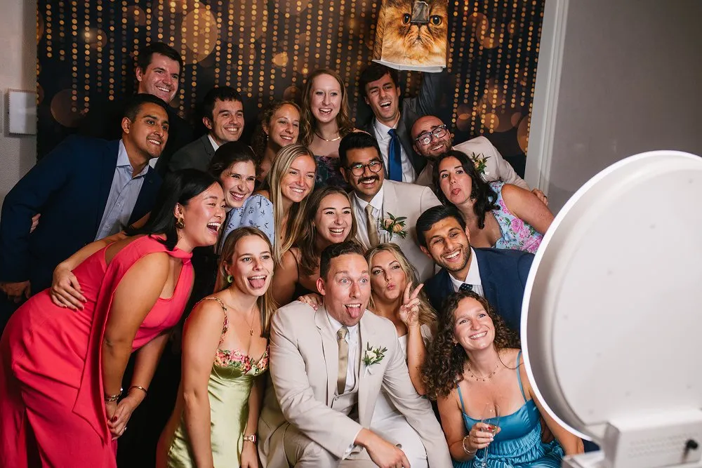 Wedding guests crowding into an FNA photo booth