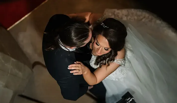 Overhead shot of a bride and groom embracing, a frame from an FNA wedding film